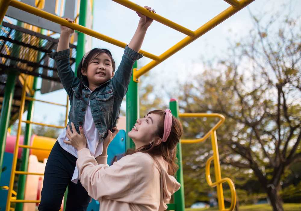 Mother playing with her daughter at park near Jewel Lake Villa in Anchorage, Alaska 