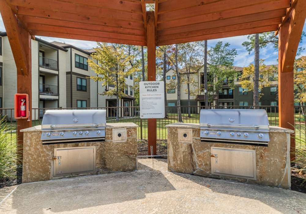 Grills by the pool at The Pines at Woodcreek in Humble, Texas