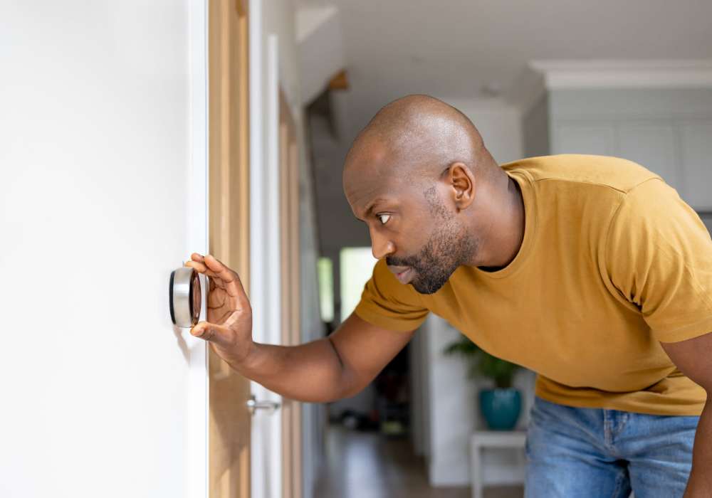 Man checking thermostat at City View Apartments in Nashville, Tennessee