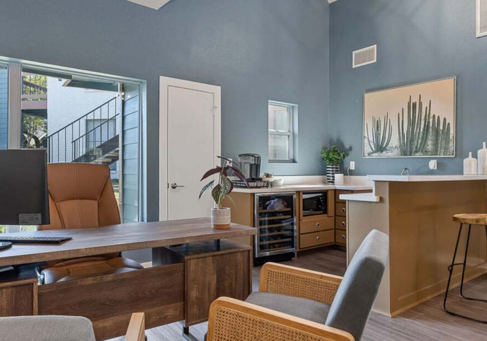 Community office with a desktop, breakfast counter and chairs at Hill At Woodway in San Antonio, Texas