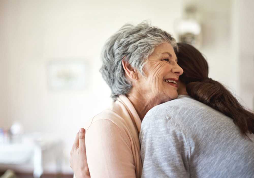 Resident embracing a family member at Merrill Gardens in Seattle, Washington