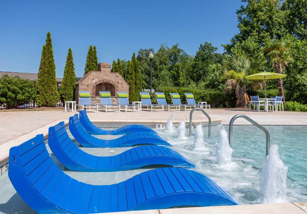 Relax on the sun ledge in the salt-water resort style pool at Maystone at Wakefield in Raleigh, North Carolina