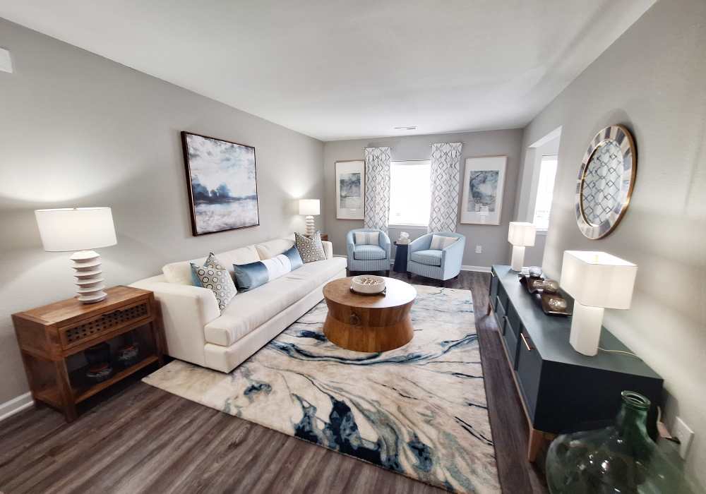 Well lit and open living room with hardwood flooring at River Landing in Myrtle Beach, South Carolina