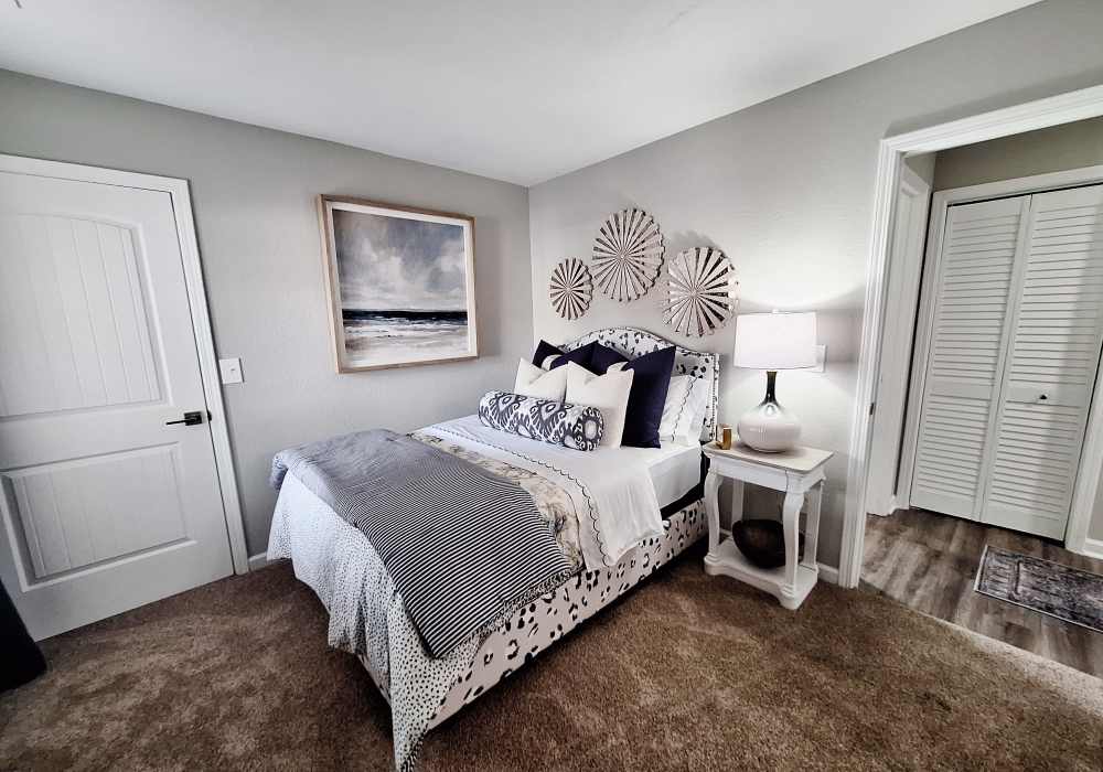 Well lit bedrooms with plush carpeting spacious closets, ceiling fan, and connected bathroom at River Landing in Myrtle Beach, South Carolina