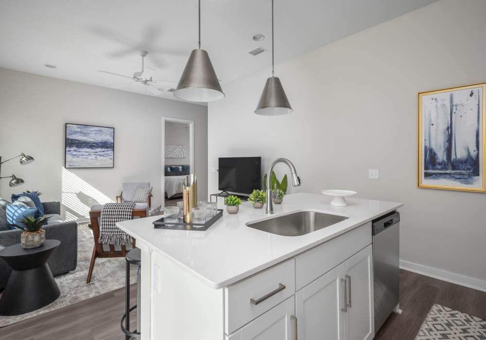 Kitchen island and living room in a model home at Cottage Street at eTown in Jacksonville, Florida