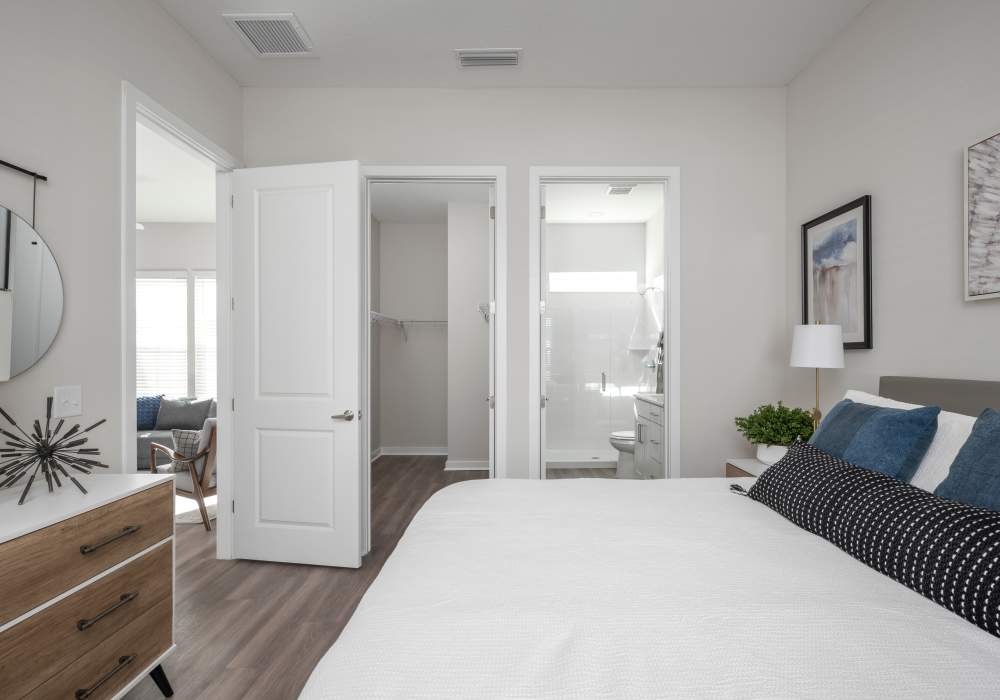 Master bedroom with large closet and bathroom in a model home at Cottage Street at eTown in Jacksonville, Florida