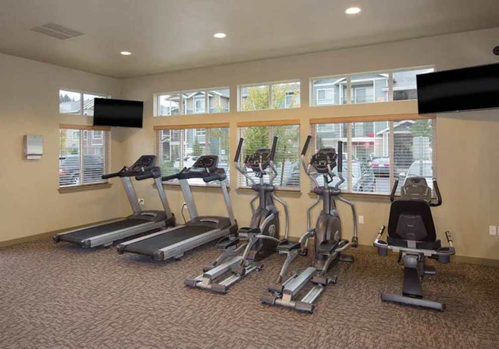 A row of cardio machines in the fitness center at Copper Lane in Vancouver, Washington