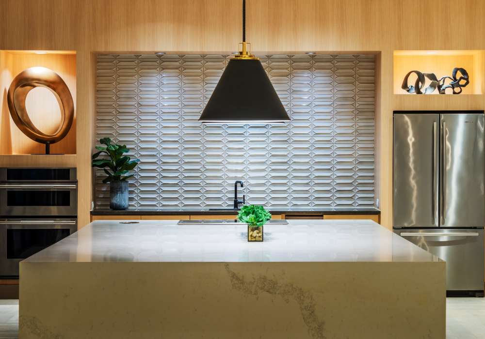 Community kitchen area with a refrigerator at The Reverie at Lake Boone in Raleigh, North Carolina