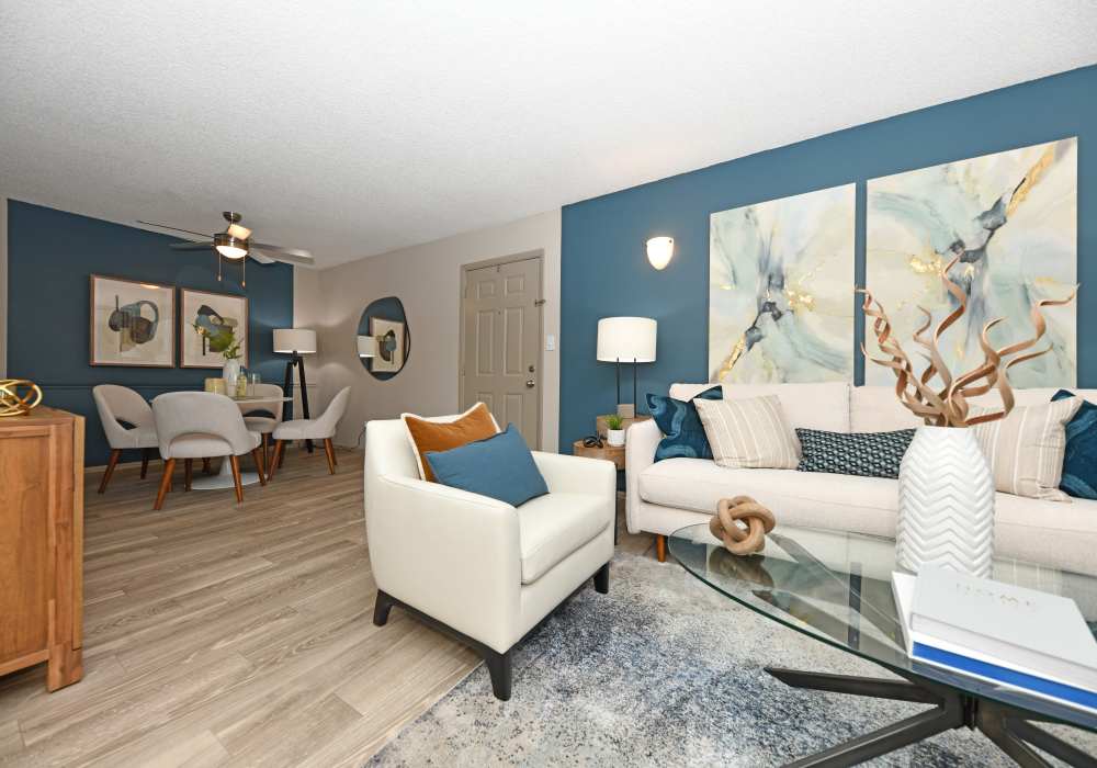 Living room with an elegant blue color palette at Ascent Apartment Homes in Asheville, North Carolina
