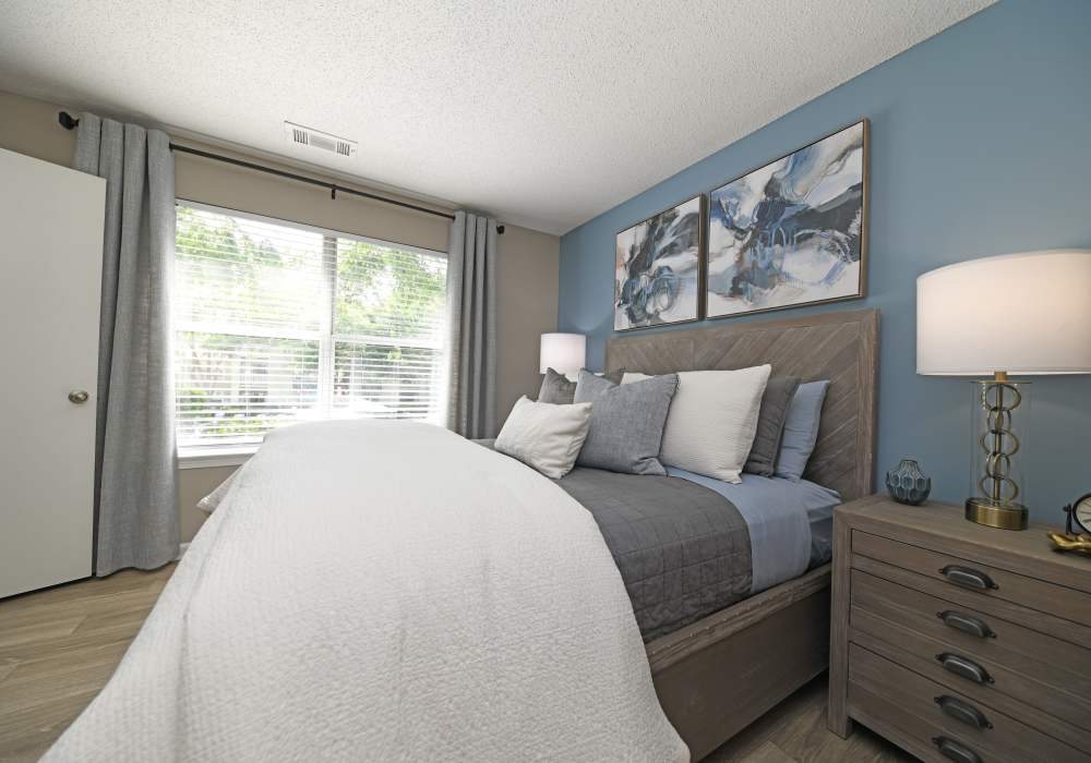 Model bedroom with wood-style flooring at Nova at Biltmore Park in Arden, North Carolina