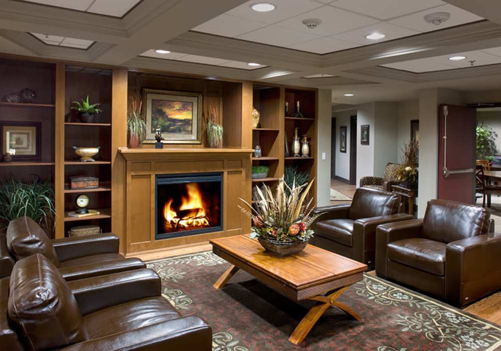 living room with leather chairs and a fireplace at The Blakely in Shoreline, Washington
