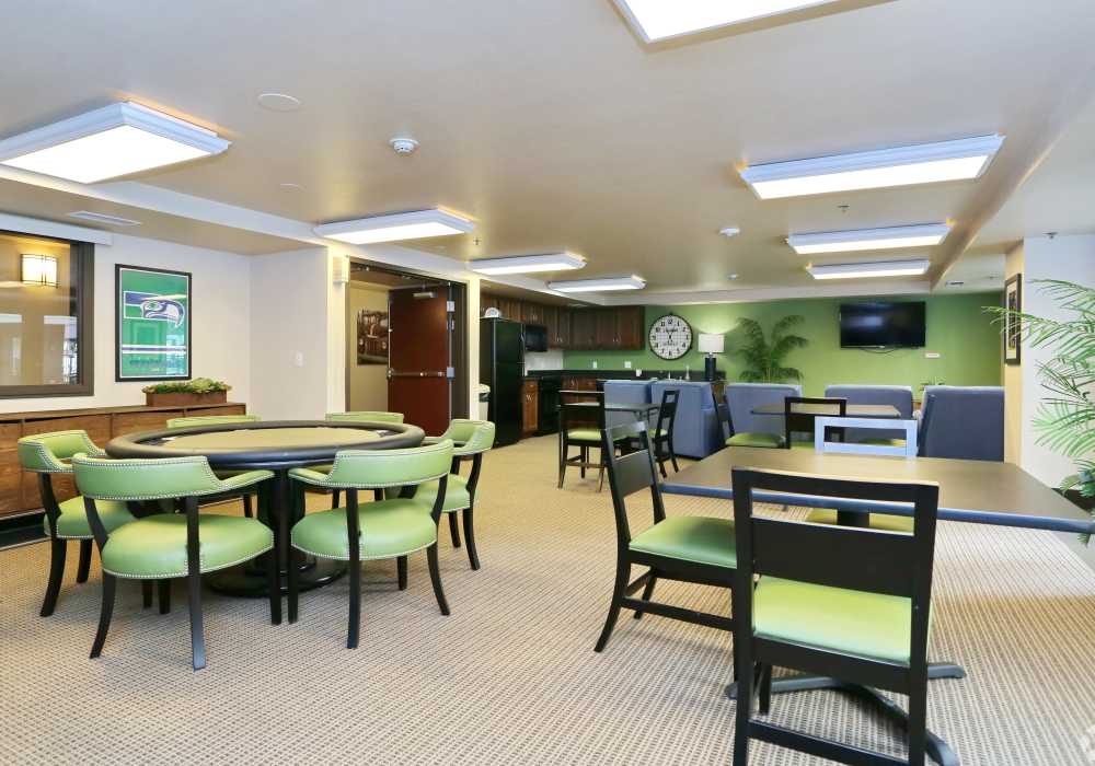 stylish dining room with green chairs and tables at The Blakely in Shoreline, Washington