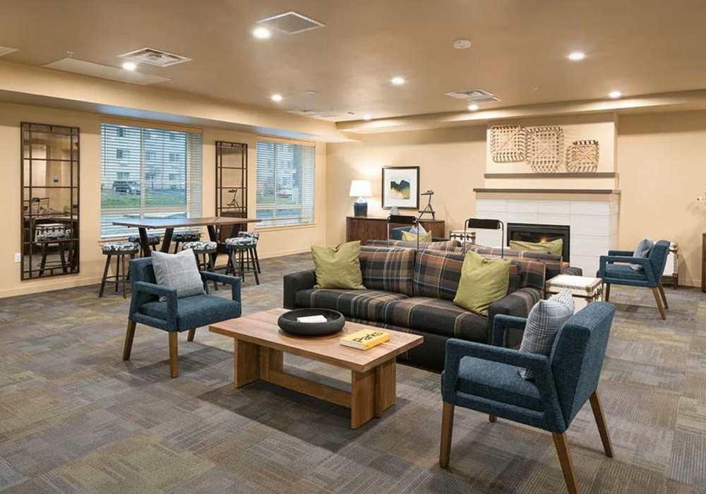 Community lounge area with tables and lots of seating at Traditions at Federal Way in Federal Way, Washington