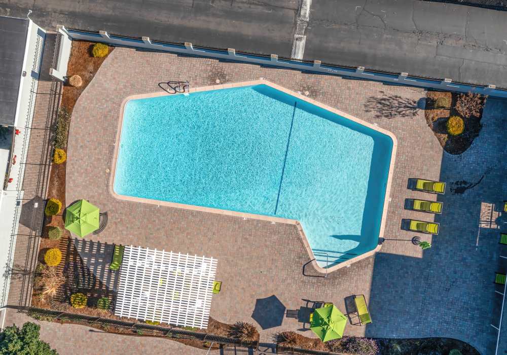 Swimming pool deck with seating around it at Briarwood Apartments in Livermore, California