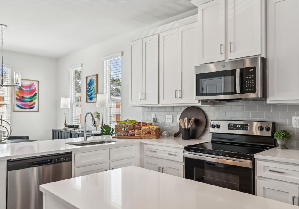 Modern kitchen with white color cabinets at Crossings At NoDa in Charlotte, North Carolina