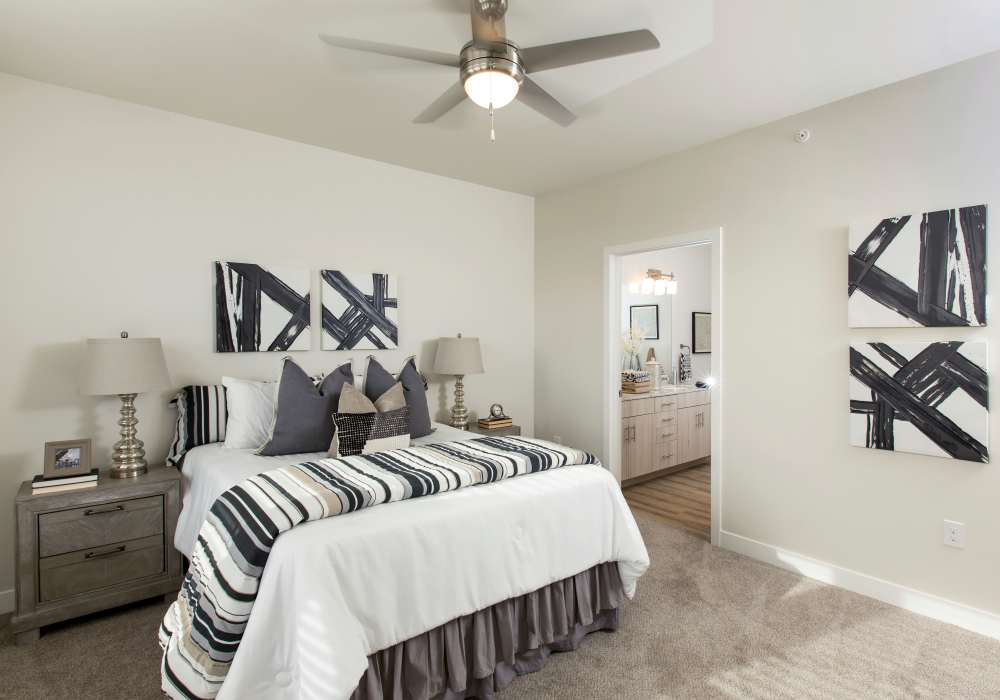 Bedroom with carpet flooring and attached bathroom at Altair At The Heights in Richmond Heights, Missouri