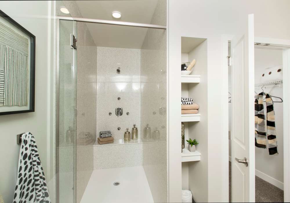 Bathroom with wood flooring, waterfall faucet sink, and shower at Altair At The Heights in Richmond Heights, Missouri