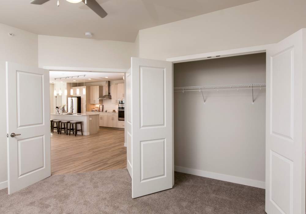 An empty bedroom with carpet and closet at Altair At The Heights in Richmond Heights, Missouri