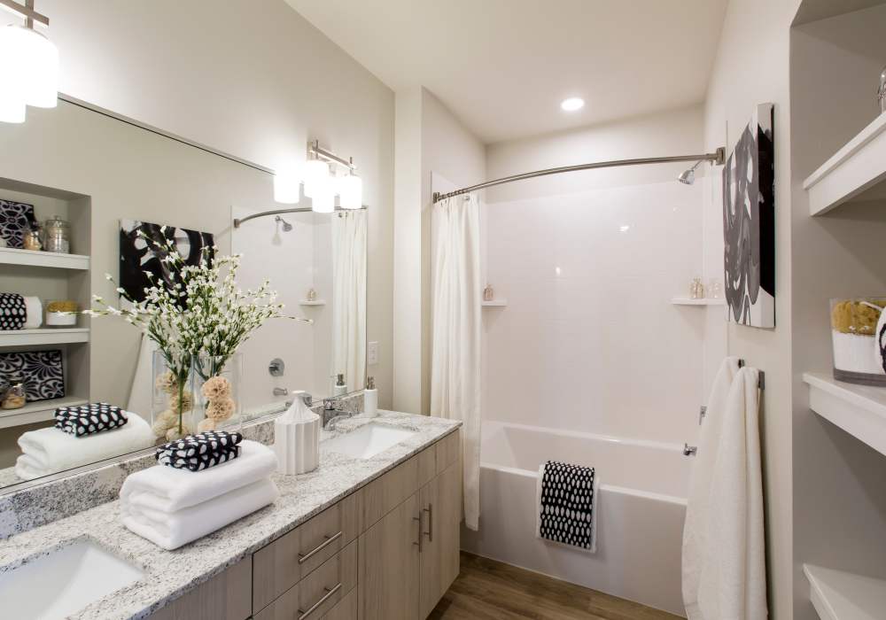 Bathroom with a toilet, sink, and standard tub at Altair At The Heights in Richmond Heights, Missouri