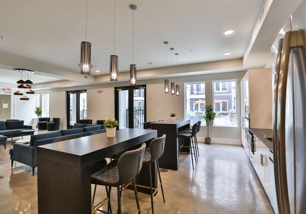 Clubhouse with walnut color furniture at Altair At The Heights in Richmond Heights, Missouri