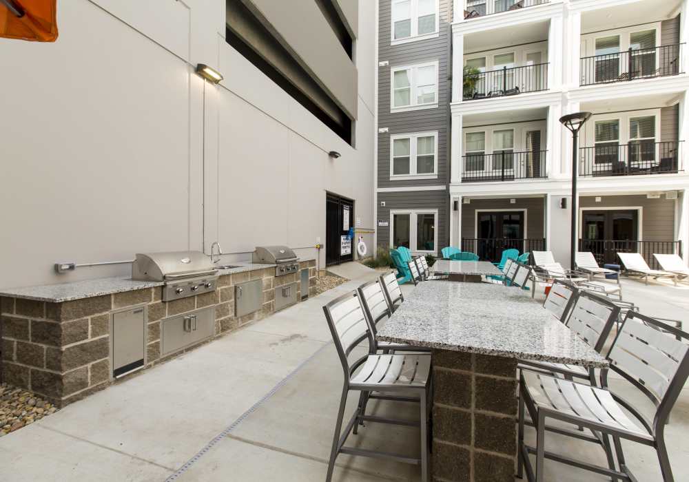 Outside seating area with grilling station at Altair At The Heights in Richmond Heights, Missouri
