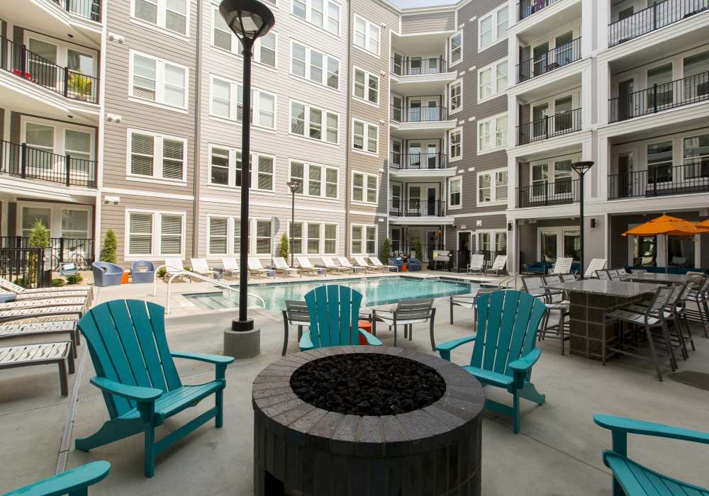 Fire pit with blue color chairs at Altair At The Heights in Richmond Heights, Missouri