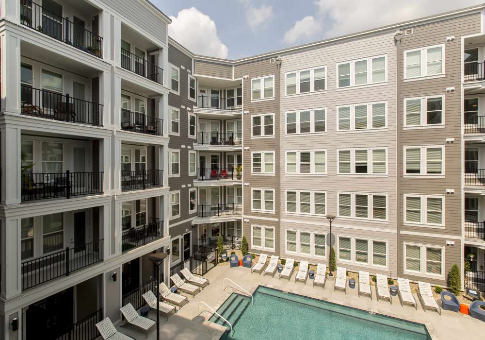 Swimming pool surround by apartment building at Altair At The Heights in Richmond Heights, Missouri