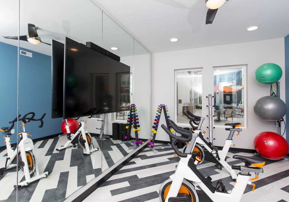 Fitness center with television and and sound bar at Altair At The Heights in Richmond Heights, Missouri