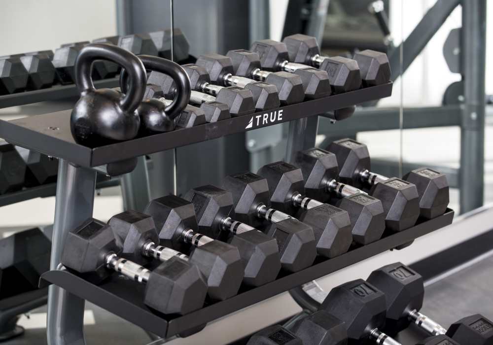 Fitness center with bumbells at Altair At The Heights in Richmond Heights, Missouri