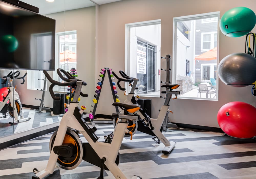 Fitness center with ellipticals at Altair At The Heights in Richmond Heights, Missouri