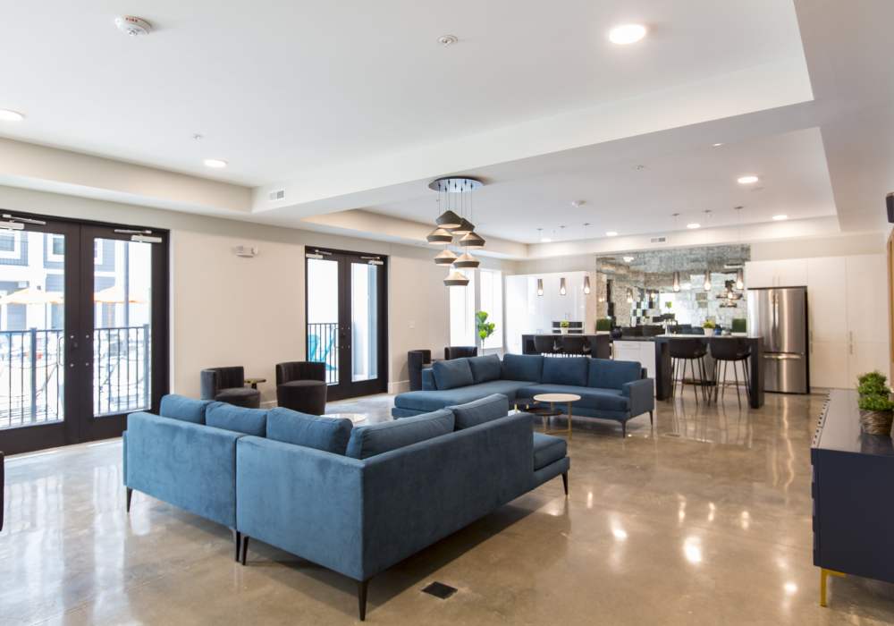 Clubhouse with blue color sofa at Altair At The Heights in Richmond Heights, Missouri