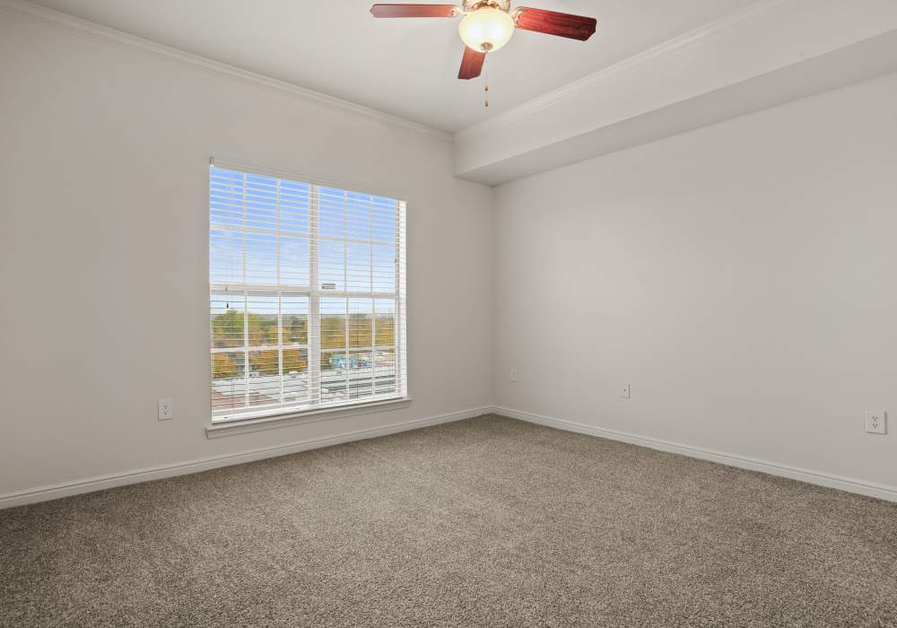 Bedroom with a ceiling fan and a window at Irving Schoolhouse Apartments in Salt Lake City, Utah