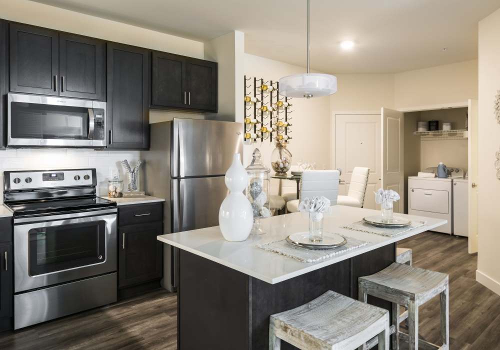 Fully-equipped kitchen with a refrigerator, ceiling light and cupboard storage at Altair At The Preserve in O'Fallon, Missouri