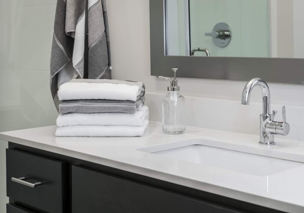 Bathroom with sink and towels at Altair At The Preserve in O'Fallon, Missouri