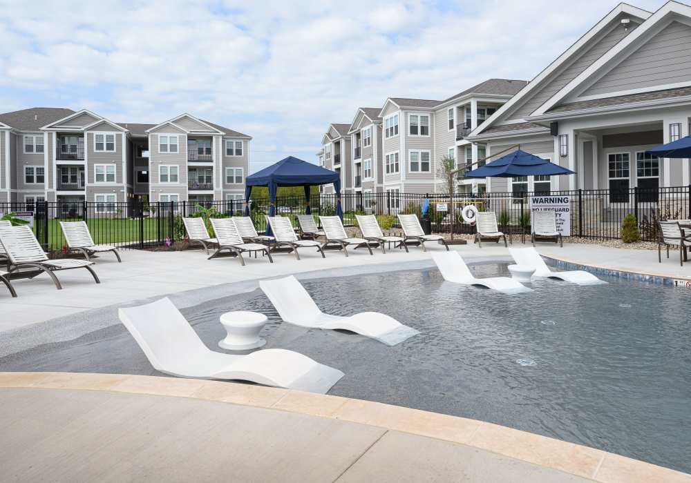 Relaxing chairs in pool at Altair At The Preserve in O'Fallon, Missouri