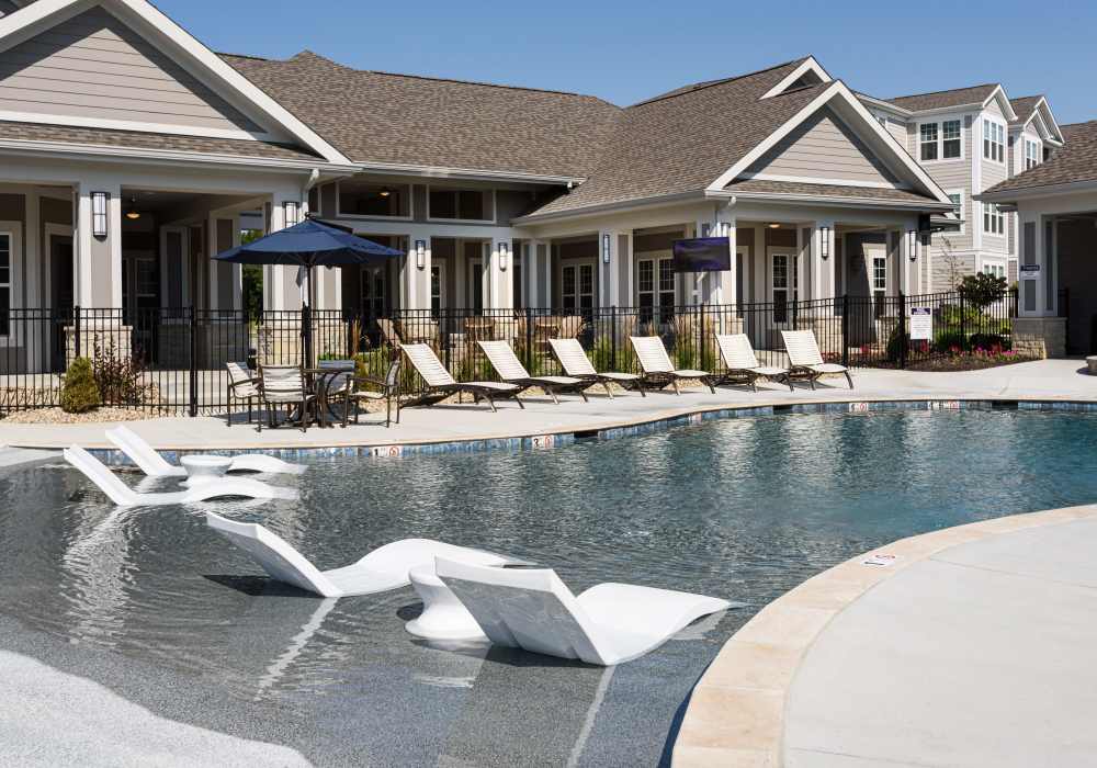 Swimming pool with white color lounge chairs at Altair At The Preserve in O'Fallon, Missouri