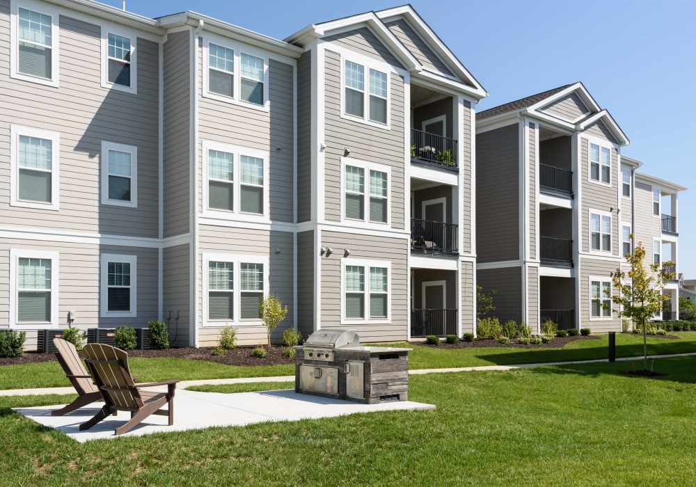 View of the building with sitting area at Altair At The Preserve in O'Fallon, Missouri