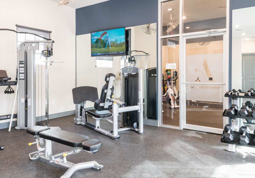 Gym room with mirrors at Altair At The Preserve in O'Fallon, Missouri