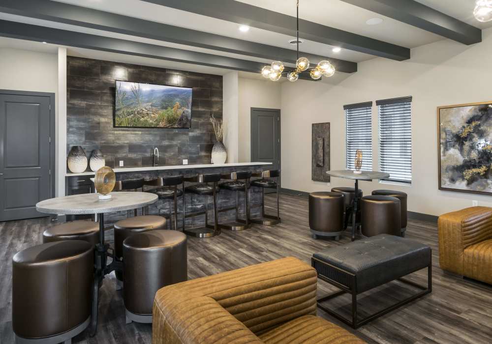 Lobby area with couch and kitchen at Altair At The Preserve in O'Fallon, Missouri