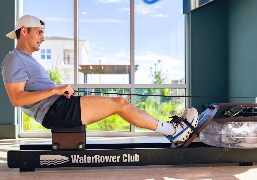 Resident using a rowing machine at The Waters at McGowin in Mobile, Alabama