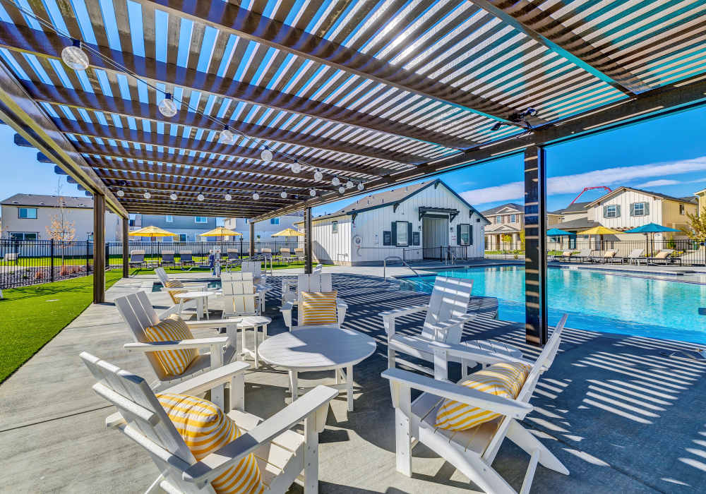 Outdoor lounge space by community pool & splash pad at BB Living at The Oaks in Meridian, Idaho
