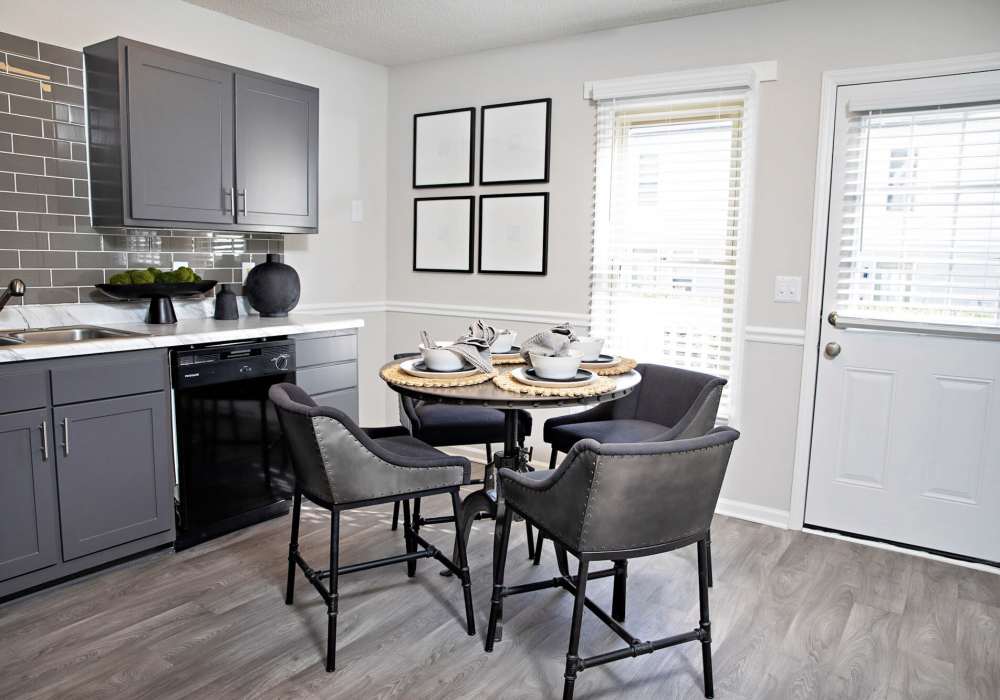Dining table in kitchen with wood-style flooring at Edge at Concord in Concord, North Carolina, 