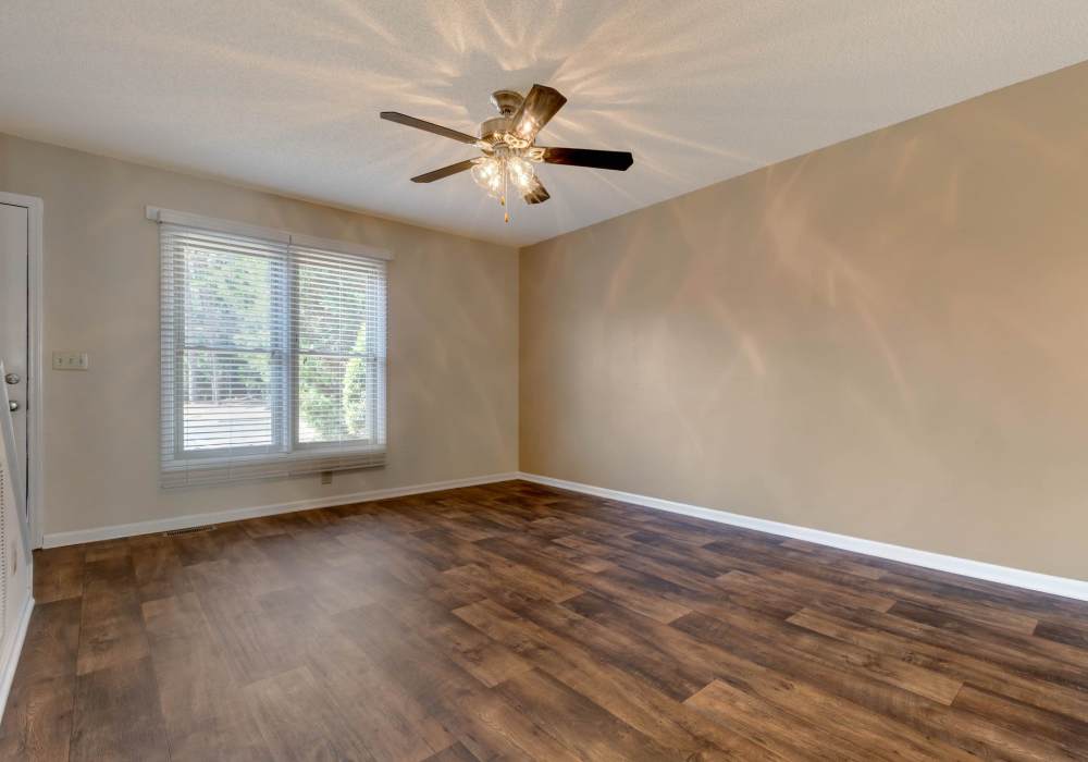 Spacious bedroom with wood-style flooring at Edge at Concord in Concord, North Carolina, 