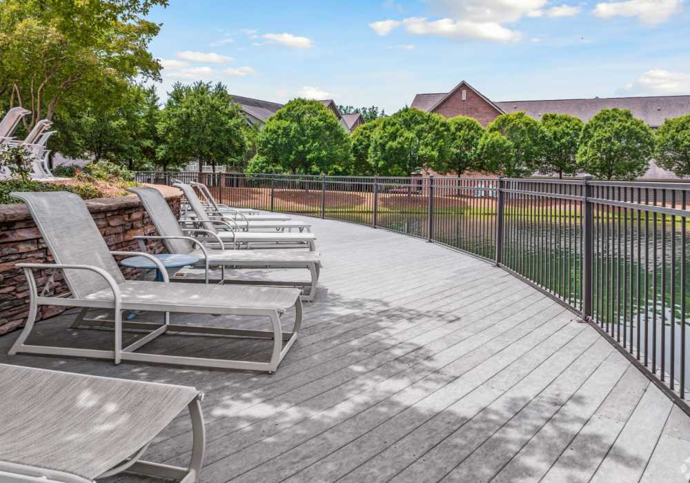 Seating for residents with a view of the lake at The Park Apartment Homes in Prattville, Alabama