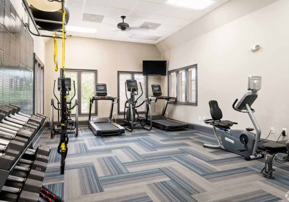 Gym with equipment and a fan at The Park Apartment Homes in Prattville, Alabama 
