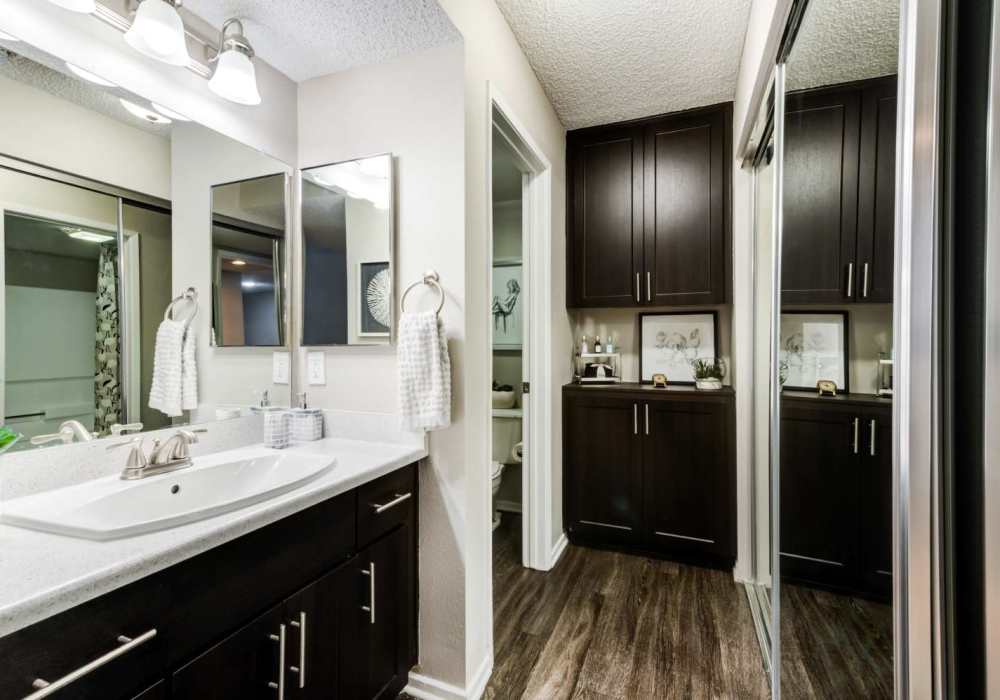 Bright bathroom with large mirror and endant lights at The Bluffs in Rancho Cucamonga, California,