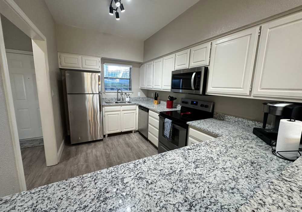 Empty apartment kitchen at Towne Square Condos at The Lodge in Granbury, Texas
