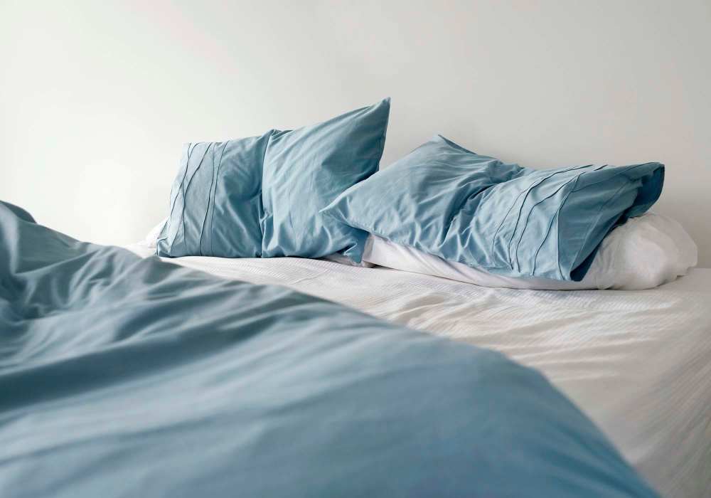 Bedroom with blue color pillow at Greer Mill Residences in Greer, South Carolina