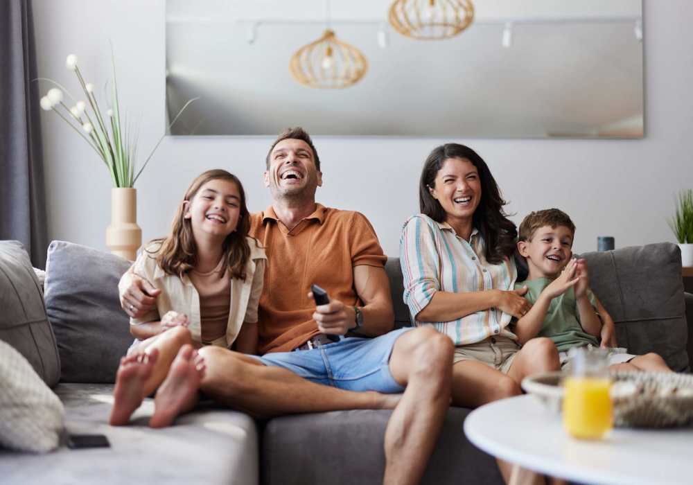 Resident family seating in living room at Greer Mill Residences in Greer, South Carolina