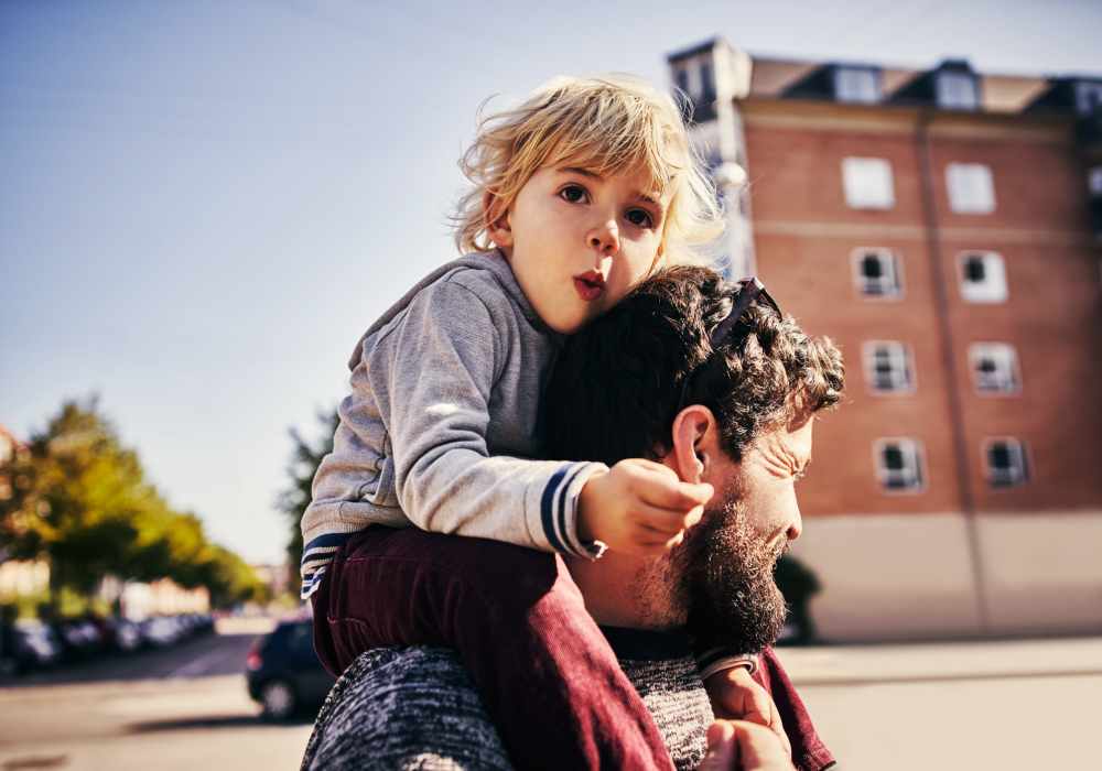 Resident child with his father in street near Greer Mill Residences in Greer, South Carolina